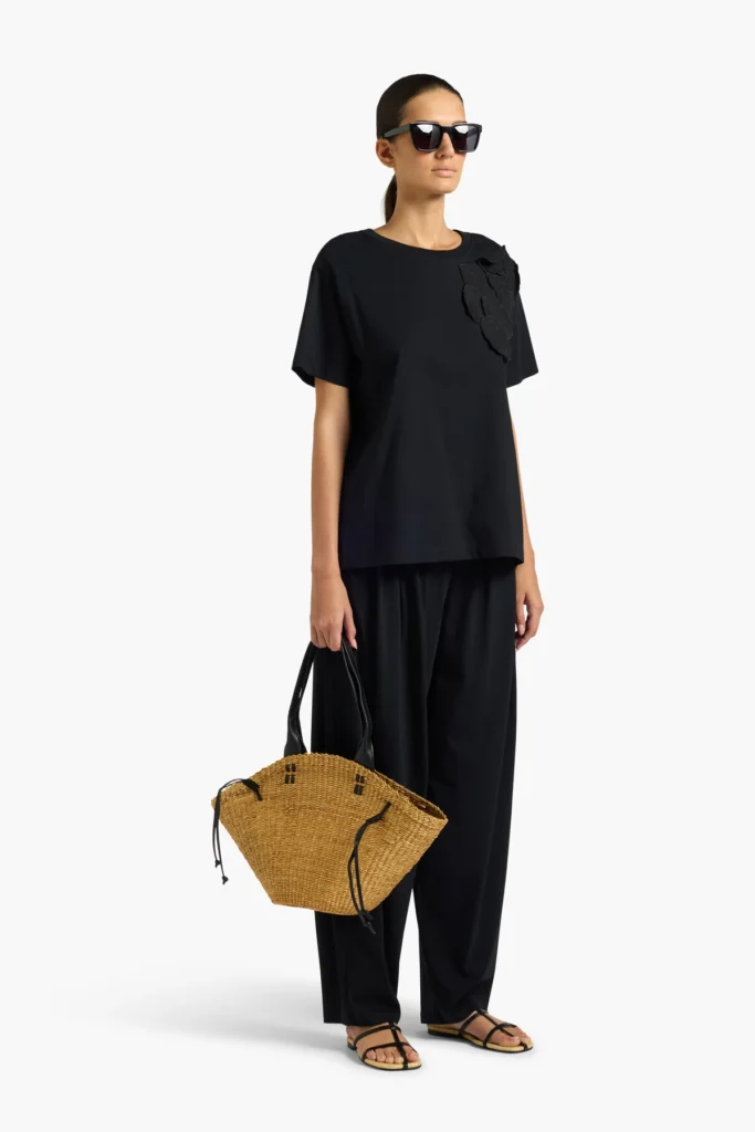 S6LL6SW73Y69 0 A Minimalistyczny T-shirt o swobodnym kroju, wykonany z miękkiej i komfortowej tkaniny, idealny do codziennych stylizacji. Klasyczny fason z krótkim rękawem i okrągłym dekoltem został uzupełniony efektowną aplikacją kwiatową, która nadaje całości nowoczesnego i kobiecego charakteru. Luźna linia zapewnia wygodę noszenia, a ponadczasowy design sprawia, że model doskonale komponuje się zarówno z eleganckimi spodniami, jak i casualowymi zestawami. Stylowa propozycja dla kobiet ceniących prostotę z wyrafinowanym detalem.